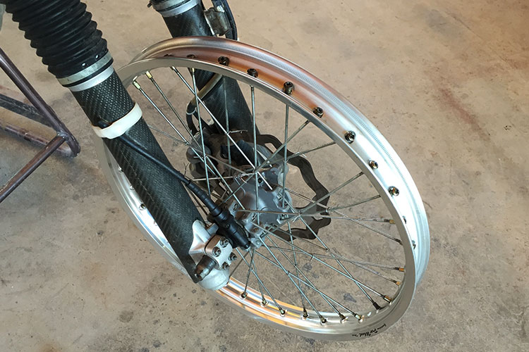 When you spin the rim you can see where it needs to be tightened or loosened. Remember the wheel is like a big spring and sometimes you need to loosen spokes to get the rim straight